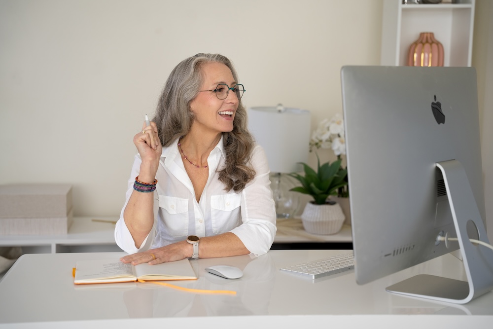 woman laughs with zoom participant